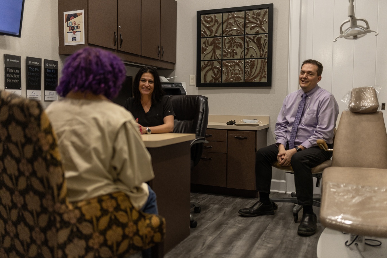 Dr. Hulme and a treatment coordinator discuss care options with a patient.